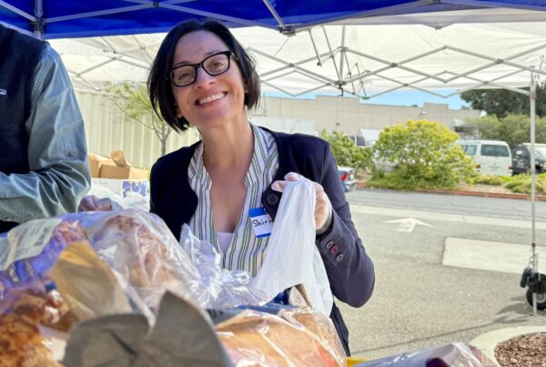 volunteer handing out food for health hubs